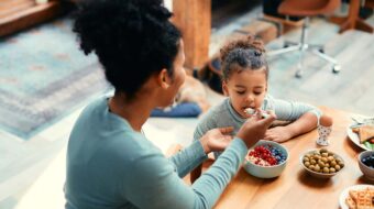 Mom feeding her daughter