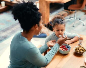 Mom feeding her daughter
