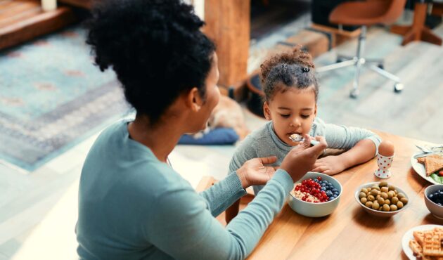 Mom feeding her daughter