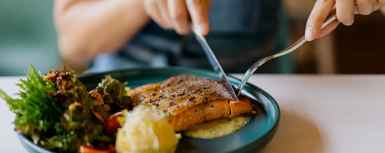 Woman eating salmon dinner