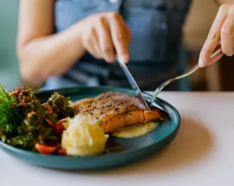 Woman eating salmon dinner
