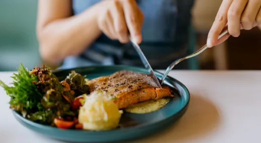 Woman eating salmon dinner