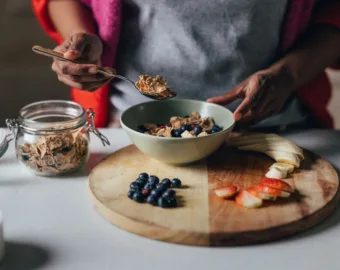 women making oatmeal with fruit toppings