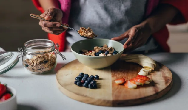 women making oatmeal with fruit toppings