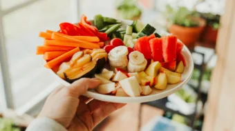 person holding colorful fruit vegetable plate